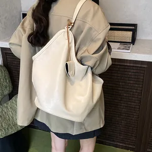 Close-up view of a large capacity cream tote bag showing soft leather texture and style