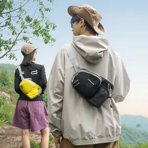Outdoor lifestyle shot of compact black and yellow crossbody bags worn by hikers.