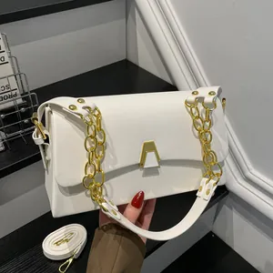 Detailed close-up view of a stylish white crossbody bag featuring elegant golden chains