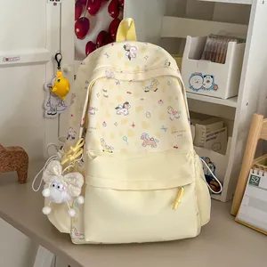 Japanese style pastel yellow backpack with cute cartoon pony prints and plush charm
