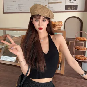 Detailed view of the vintage brown frayed beret hat on a female model in a cafe setting.