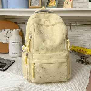 High-capacity cream yellow casual backpack with butterfly patterns in a cozy setting.