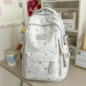 Refreshing Korean style backpack with star and maple leaf patterns on a study desk