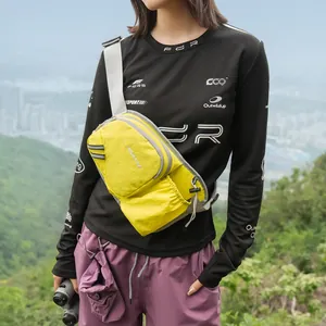Vibrant yellow nylon crossbody chest bag for women shown during an outdoor hiking trip