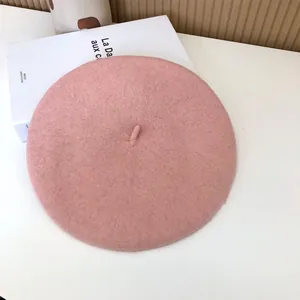 Detailed view of a minimalist pink wool felt beret with soft texture for winter fashion