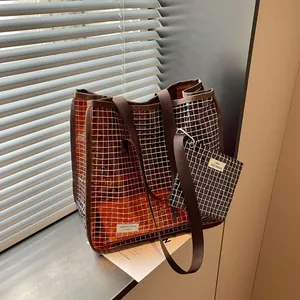 Detail view of stylish brown transparent grid tote bag set with matching small pouch