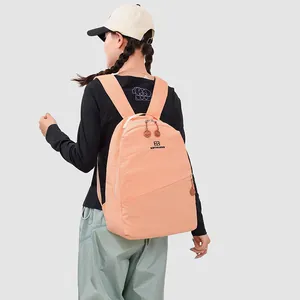 Back view of a young woman wearing a peach-colored Japanese style large capacity backpack outdoors