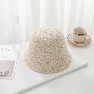 Warm and cozy beige lamb wool bucket hat for winter displayed with minimalist lifestyle props