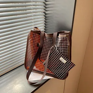 Detailed view of a vintage brown grid pattern tote bag set with matching small pouch accessory