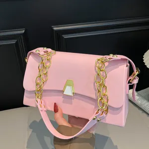 Elegant pink small square bag featuring a gold chain strap and geometric clasp.