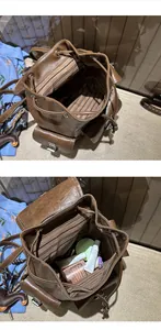 Close-up view of the spacious brown leather backpack interior with striped lining