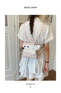Detailed back view of a model wearing a cute pink puppy-themed backpack with plush charm