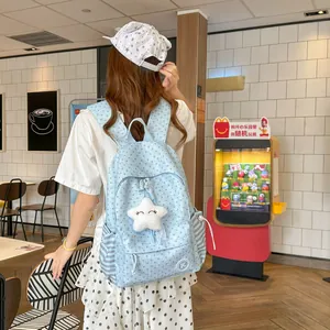 Detailed view of a light blue star pattern backpack with a cute plush star shaped pendant
