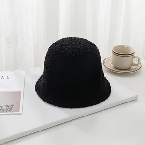 Detailed macro view of black lamb wool bucket hat with soft texture on a minimalist setup