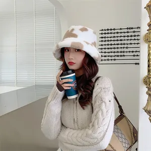 Detail view of a stylish plush cow print bucket hat worn in a winter setting