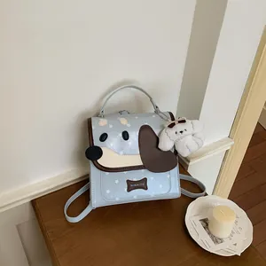Close-up of a cute light blue dog-themed backpack with star pattern and plush puppy charm.