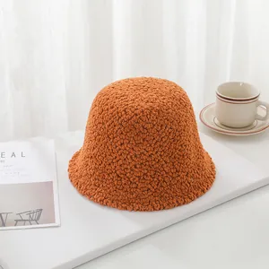 Close-up of orange sherpa wool bucket hat showing thick fuzzy texture for winter