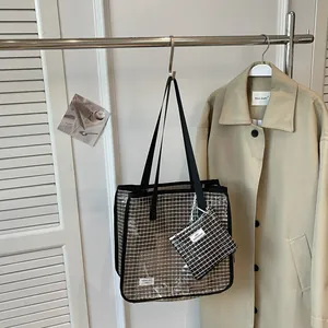Close-up detail of a large capacity grid pattern tote bag with a matching pouch.