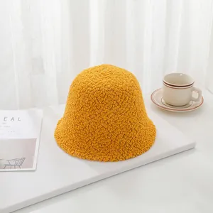 Close-up of yellow lamb wool bucket hat with soft sherpa texture for winter warmth.
