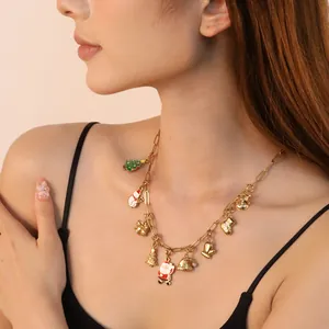 Detailed macro view of a festive Christmas charm necklace on a model showing 18K gold details