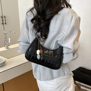 Stylish black crocodile-embossed dumpling hobo bag featuring a colorful bead charm accessory