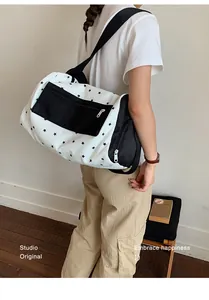 Stylish star-patterned fitness travel bag shown worn as a comfortable shoulder bag.