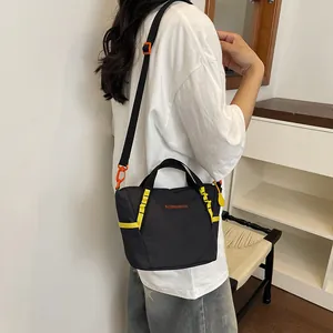 Close-up detail of the black women's fitness yoga bag with vibrant yellow straps