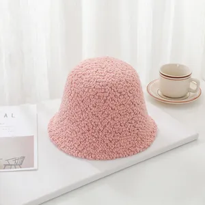 Macro view of the soft pink sherpa lamb wool texture on this cozy winter bucket hat.