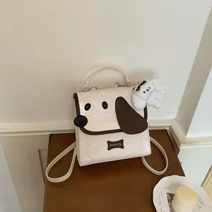 Detail shot of a cute cream-colored dog-themed backpack with a plush charm accessory.
