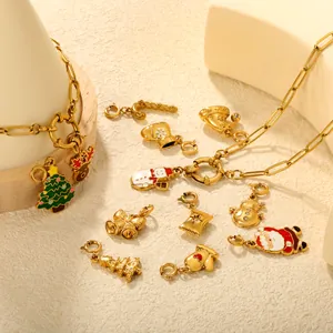 Detailed view of 18K gold-plated Christmas charms with festive enamel motifs