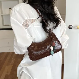 Sophisticated dark brown crocodile embossed hobo bag featuring a unique colorful bead charm.