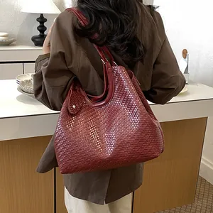 Stylish large burgundy woven tote bag with high-capacity shoulder design for women.