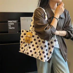 Stylish large capacity polka dot tote bag with cute bear charm shown on model for daily use