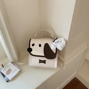 Close-up of cute dog-shaped mini backpack with plush puppy charm and bone tag.