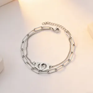 Silver stainless steel double-layered necklace featuring interlocking handcuff pendant