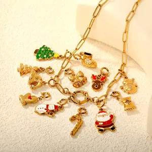 Detail macro shot of 18K gold plated Christmas charms on a dainty stainless steel chain
