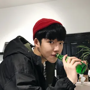 Asian male model wearing a trendy red knit beanie sailor hat in a lifestyle setting