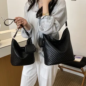 Detail shot of stylish black woven bucket bags in two sizes with matching pouches