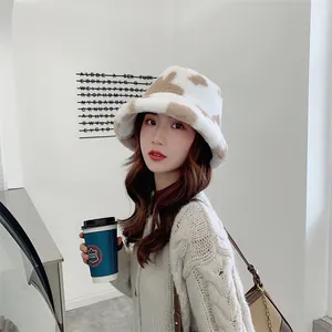 Stylish cow print plush bucket hat worn by a model in a minimalist winter lifestyle setting