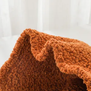 Macro detail of brown lambswool fabric on a warm winter bucket hat.