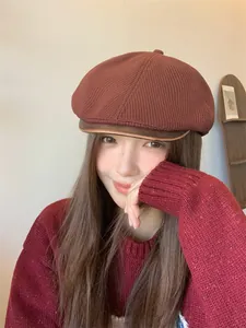 Asian model wearing a retro British style knitted newsboy hat in autumn colors.