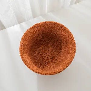 Top-down view of an orange lamb wool bucket hat showing its thick and soft plush texture