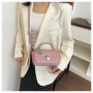 Fashionable pink mini square bag with beaded top handle and metallic silver buckle detail