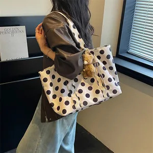 Large capacity women's white tote bag with black polka dots shown in a lifestyle setting