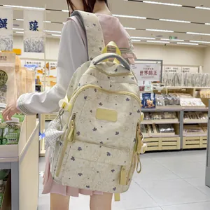 Stylish girl wearing a cream star and leaf print backpack in a modern store setting