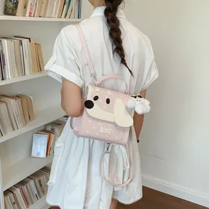 Detailed view of a cute pink dog-themed backpack worn on the back of a young girl