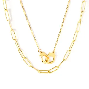 Elegant gold plated double-layered necklace featuring handcuff pendant and paperclip chain.