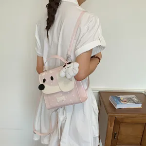 Detailed view of a cute pink puppy design backpack featuring a soft plush bear charm