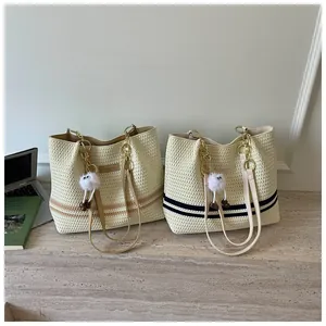 Stylish woven tote bags in two colors featuring striped details and cute monster charms