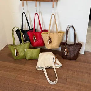 Detailed view of stylish solid color woven tote bags with beaded tassels in various colors
